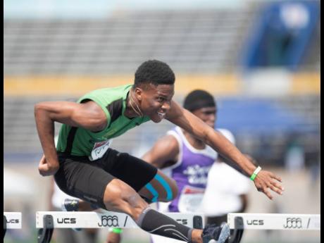 
Jerome Campbell of Calabar High clears the final hurdle while competing in the Class  One boys’ 110m hurdles during the S.W. Isaac-Henry Invitational Meet at the National Stadium yesterday. Campbell won in a meet record 14.04 seconds.