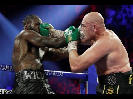 Tyson Fury (right) of England lands a right to Deontay Wilder during a WBC heavyweight championship match in Las Vegas, Nevada, on Saturday.