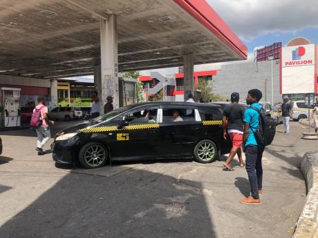 Taxis parked at the Total petrol station at 11A Constant Spring Road in St Andrew waiting for passengers. Many of the taxis, with engines running, load passengers on the pump, posing grave dangers to members of the public and operators at the station.