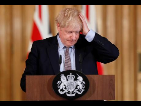 Britain’s Prime Minister Boris Johnson reacts during a press conference at Downing Street on the government’s coronavirus action plan in London yesterday.