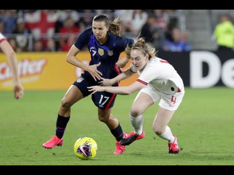 United States’ Tobin Heath (left) and England’s Kiera Walsh battle for possession of the ball during the first half of a SheBelieves Cup football match on Thursday, March 5, in Orlando, Florida. The USA won 2-0.
