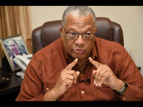 Opposition Leader Dr Peter Phillips makes a point during an interview at the Office of the Opposition Leader on Monday.
