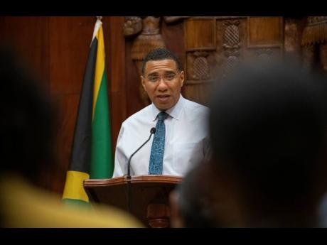 Prime Minister Andrew Holness fields questions from journalists at a press conference at Jamaica House yesterday evening. The island confirmed its second COVID-19 case.