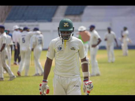 
Jamaica Scorpions batsman Marquino Mindley leaves the field after he was dismissed by Barbados Pride fast bowler Chemar Holder during a regional match at Sabina Park recently.