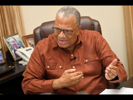 Dr Peter Phillips gestures during an interview with The Gleaner at the Office of the Opposition Leader.