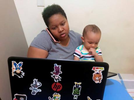 Kayla Wright-Abbott, a creative client services assistant, juggles work and play with her one-year-old son. Many Jamaicans have taken up the option to work from home because of stipulations issued by the Jamaican Government to limit the spread of novel coronavirus infections.