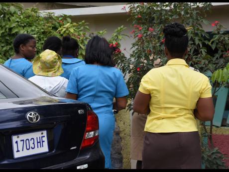 Healthcare workers were conducting temperature checks on residents of Pondside in St Thomas on Thursday, as Jamaica seeks to contain a COVID-19 outbreak.
