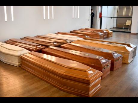Coffins are lined up on the floor in the Crematorium Temple of Piacenza, Northern Italy, saturated with corpses awaiting cremation due to the coronavirus emergency yesterday. 