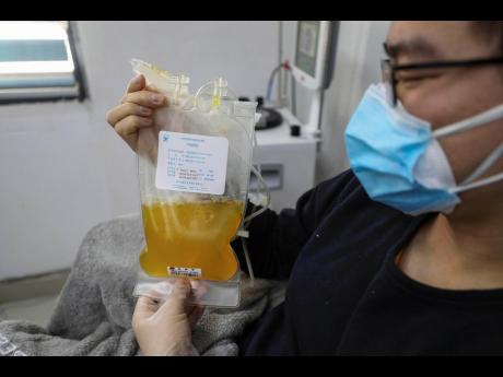 Dr Zhou Min, a recovered COVID-19 patient who has passed his 14-day quarantine, donates plasma in the city’s blood centre in Wuhan in central China’s Hubei province.