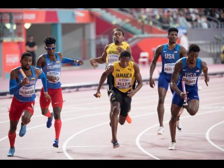 Jamaica’s Nathon Allen (centre) embarks on the second leg in the men’s 4x400m relay final after receiving the baton from Akeem Bloomfield (back centre) at the World Athletics Championships in Doha, Qatar, on Sunday, October 6, 2019.