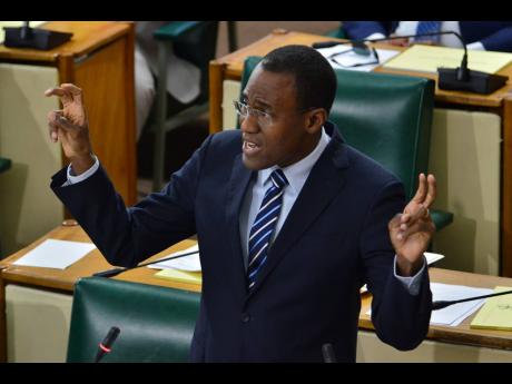 Dr Nigel Clarke, minister of finance and the public service, gestures during a presentation in Parliament on Tuesday.
