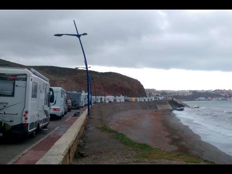 Stranded tourists in motor homes queue in northern Morocco, near the Spanish enclave of Ceuta. (AP)
