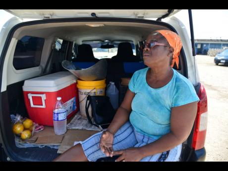 Because of social-distancing concerns, fish vendor Paulette Coley has opted to sell from her car at the Old Harbour Bay fishing village. 