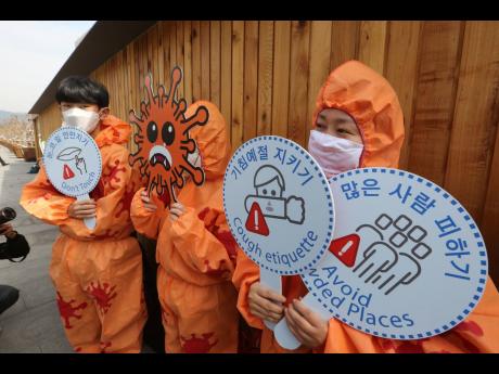 Environmental activists hold a coronavirus-prevention campaign in Seoul, South Korea, on Thursday.