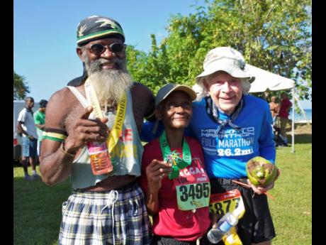Burt Carlson (right) posing with fellow Reggae Marathon runners at the end of  his 2013 race. At left is Locksley Buchanan while at centre is Gerline Nelson.