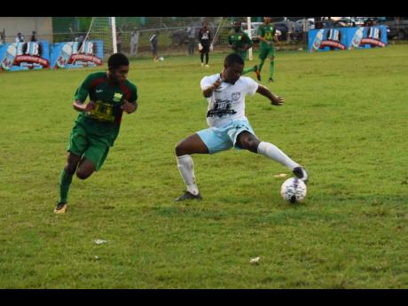 Faulkland FC players Marvin Sangster (right) and Tyshan Hill, then of Wadadah FC, during the final of the JFF Western Confederation/Charle’s JB Rum Super League at Jarrett Park last season. 