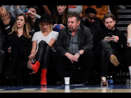 New York Knicks owner James Dolan (second right) watching an NBA game against the Memphis Grizzlies at Madison Square Garden in New York City on Thursday, January 30.