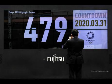 A man takes pictures of a countdown display for the Tokyo 2020 Olympics in Japan yesterday. The countdown clock is ticking again for the Tokyo Olympics now set for July 23 to August 8, 2021. The clock says 479 days to go. 