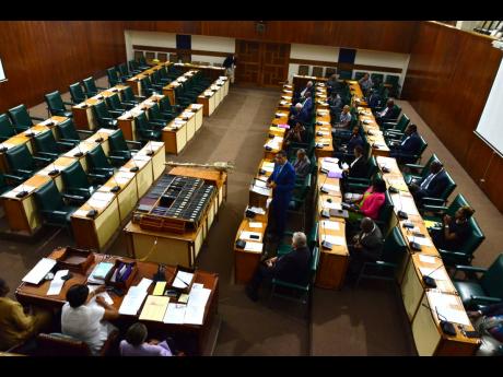 Prime Minister Andrew Holness makes a statement to Parliament during a hastily arranged sitting of the House of Representatives yesterday. The Opposition said they were informed too late and had counterproposed a Wednesday morning sitting.