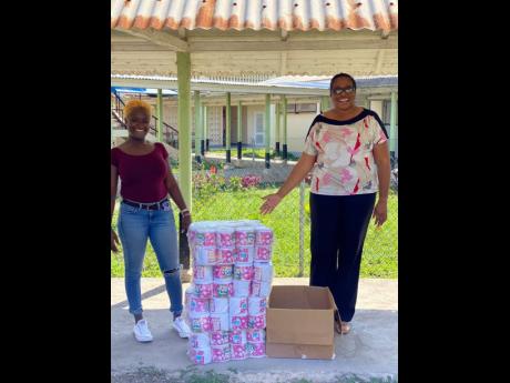 Karen Lloyd (left), representative of IBE Limited, stands with Lionel Town Hospital Chief Executive Officer Nadine Preddie during a hand over of supplies to the hospital. IBE Limited, co-promoters of the popular Strictly 2K and Soca Forever events, made donations of toiletries and sanitising agents to the Michelle Gabriel Old Age Home and Lionel Town Hospital in Clarendon.