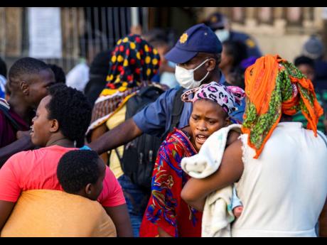 Police remove foreign migrants from the Central Methodist Church in Cape Town, South Africa, yesterday.