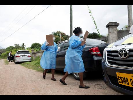 Healthcare workers canvassing householders in Corn Piece Settlement, one of the flashpoints of COVID-19 spread in Jamaica. Several cases throughout Clarendon have been linked to the 79-year-old Corn Piece man who died in mid-March.