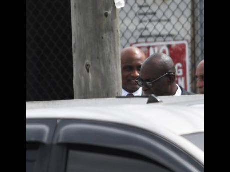 Ruel Reid (foreground) and Fritz Pinnock bail hearing at the Corporate Area Parish Court.