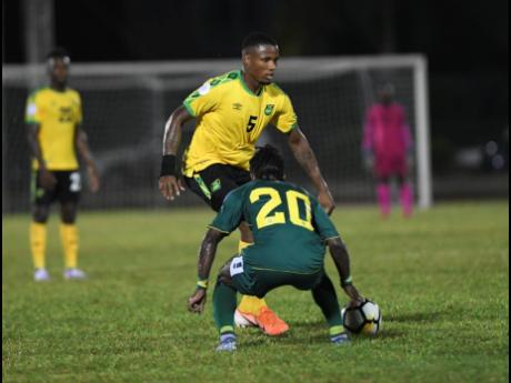 FILE
Jamaica’s Alvas Powell attempts to go past Guyana’s Trayon Bobb during a Concacaf Nations League match at the Montego Bay Sports Complex on Novembert 18 last year.