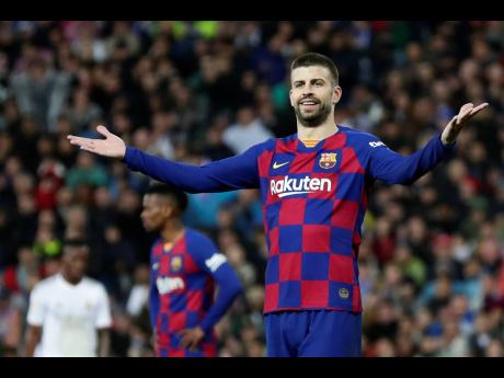 
Barcelona’s Gerard Pique reacts during the Spanish La Liga match between Real Madrid and Barcelona at the Santiago Bernabeu stadium in Madrid, Spain, Sunday, March 1, 2020. 