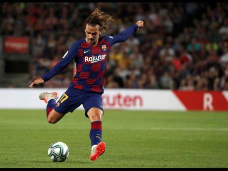 Barcelona forward Antoine Griezmann takes a shot on during their LaLiga game against Valencia at Estadio Camp Nou in Barcelona, Spain on Saturday, September 14, 2019.