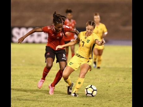Trinidad and Tobago’s Patrice Superville challenges Jamaica’s Chinyelu Asher (right) during a Concacaf Women’s Championship game at the National Stadium on Friday, August 31, 2018.