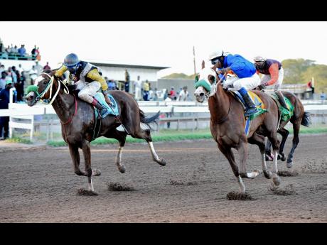 PRINCE CHARLES (right), ridden by Reyan Lewis, wins the Ash Wednesday Trophy ahead of WARTIME, ridden by Raddesh Roman at Caymanas Park on Wednesday, February 26.