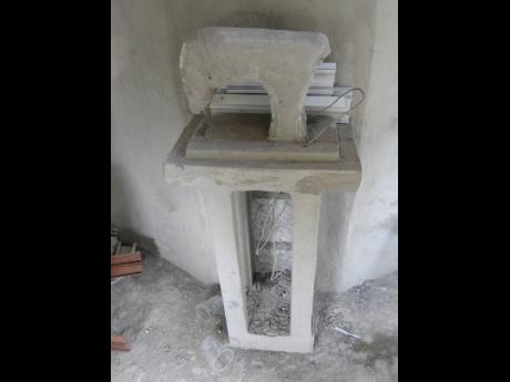 The unfinished sewing machine in the monumental tomb in Annotto Beach Cemetery in St Mary.