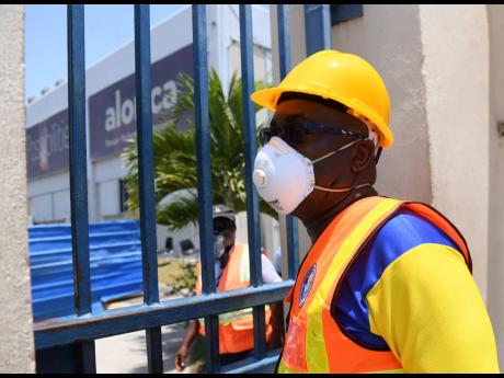 Portmore Mayor Leon Thomas standing at the entrance to Alorica facility where two workers recently tested positive for the coronavirus.