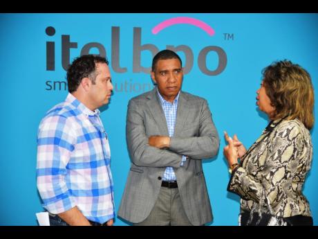 Prime Minister Andrew Holness converses with Yoni Epstein, founder and executive chairman of itelbpo Smart Solutions (left), and head of JAMPRO, Diane Edwards, following the official opening of the state-of-the-art campus of itelbpo in Montego Bay on October 5, 2017. The company has a workforce of 1,900 workers in Jamaica.  