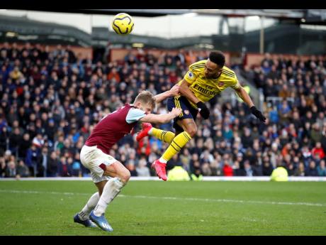 Arsenal’s Pierre-Emerick Aubameyang (right) and Burnley’s Ben Mee battle for the ball during their English Premier League match at Turf Moor, Burnley, England, on Sunday, February 2.