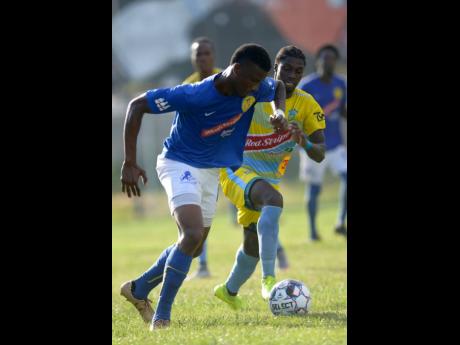 Colorado Murray of Waterhouse FC tracks the run of Vere United’s Tashaine Campbell (left) during their Red Stripe Premier League encounter at the Drewsland Stadium on Thursday, September 12, 2019.