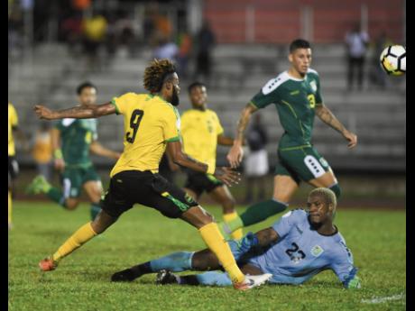 Jamaica’s Ricardo Morris (left) has an opportunity on goal as Guyana goalkeeper Quillan Roberts (on ground) rushes out during their Concacaf Nations League game at the Montego Bay Sports Complex in St James on Monday, November 18, 2019.