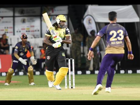 In this September 2019 file photo, Chris Gayle (left) plays a shot while representing the Jamaica Tallawahs against the Trinbago Knight Riders in the Caribbean Premier League Twenty20 cricket tournament at Sabina Park.