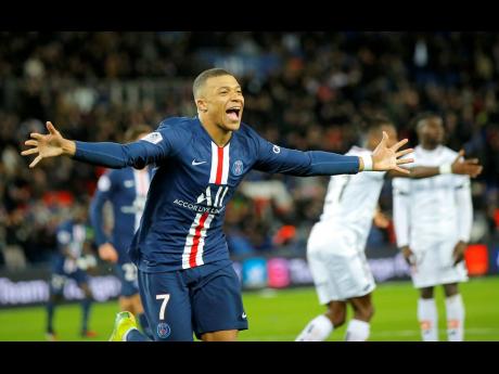 Paris Saint-Germain’s Kylian Mbappe celebrates after scoring his side’s fourth goal during their French Ligue 1 match against Dijon, at the Parc des Princes stadium in Paris, France, on Saturday, February 29.