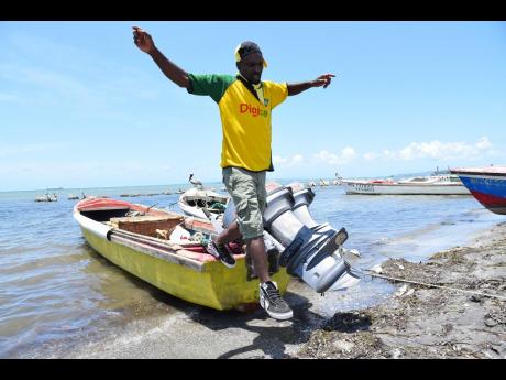 Paul Blackhood, a fishing boat captain, disembarks at the Old Harbour Bay beach in St Catherine. 