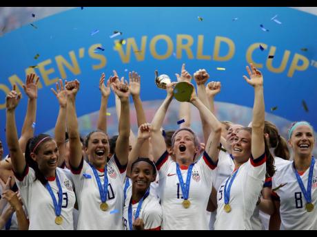 
In this July 7, 2019, file photo, United States’ Megan Rapinoe lifts up the trophy after winning the Women’s World Cup final match between US and The Netherlands at the Stade de Lyon in France.