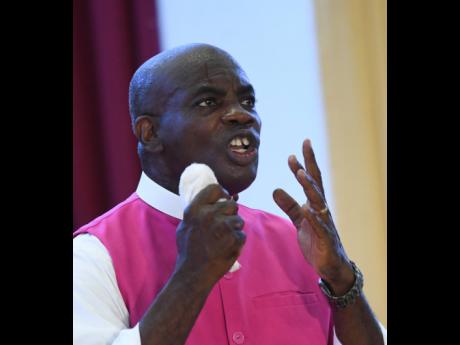 Pastor Alvin Bailey preaching at the drive-in worship service at Portmore Holiness Christian Church on Sunday.