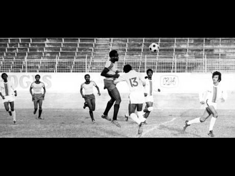In this file photo from December 1974, Cavalier player Arthur Lattimore (centre) outjumps teammates and opponents to meet a cross with a header on goal during the Kingston and St Andrew Football Association Major League final against Elleston Flats at the National Stadium in Kingston.