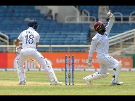 Windies wicketkeeper Jahmar Hamilton  makes an appeal to the umpire against India captain Virat Kohli in front of empty stands at Sabina Park in Kingston during day one of their second Test match on Friday, August 30, 2019. Although the lack of turnout at the time was not forced because of restrictions on gathering, many sporting events, including the upcoming Test between the Windies and hosts England, could have a similar look when they resume, because of safeguards against the spread of COVID-19.