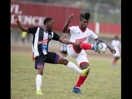 Cavalier FC’s Dwayne Atkinson (left) tackles Shemar Hunter of UWIFC in a Red Stripe Premier League match played at the UWI, Mona Bowl on Sunday, February 23, 2020.