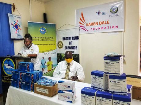 Anne-Marie Bishop, president of the Ocho Rios Rotary Club, and Delroy Morgan, acting CEO of the St Ann’s Bay Regional Hospital, sort through supplies donated to the St Ann’s Bay Regional Hospital by the Karen Dale Foundation and the Rotary Club of Ocho Rios recently. 