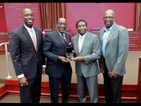 Then Minister of Education Ruel Reid (second left) accepts the keys to Broward County from County Commissioner Dale Holness at the Third Biennial Advancement Education Summit held at the Miramar City Hall. The three-day summit was hosted by the Jamaica Diaspora Education Task Force. With them are Miramar Mayor Wayne Messam (left) and Leo Gilling, chairman of the Diaspora Education Task Force.