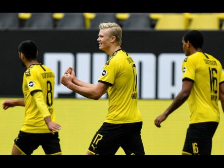 
Dortmund’s Erling Haaland (centre) celebrates after his team scored during the German Bundesliga match between Borussia Dortmund and Schalke 04 in Dortmund, Germany, yesterday.