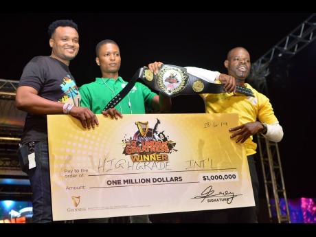 Nathan Nelms (left), brand manager of Guinness, hands over the championship belt and a symbolic cheque to High Grade International’s Mix-up Shacka (right) and Shaun Boasy after the dub-for-dub round at the Guinness Sounds of Greatness final last year.